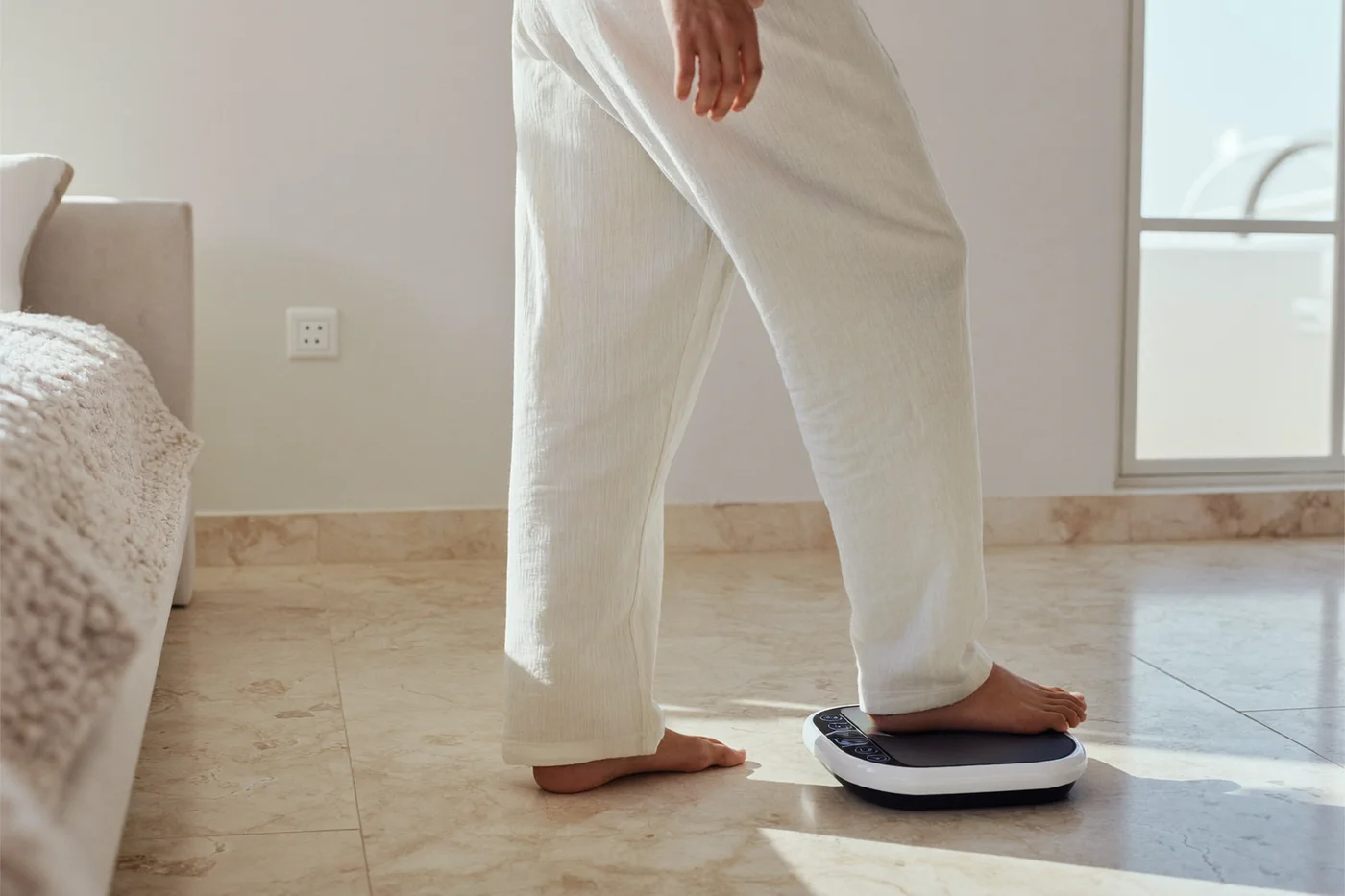 Man standing calmly on a home scale in a bright morning room